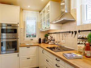 a kitchen with white cabinets and a sink at Holiday Home Hanna by Interhome in Balatonlelle