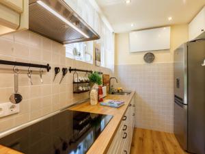 a kitchen with a sink and a refrigerator at Holiday Home Hanna by Interhome in Balatonlelle +33 photos