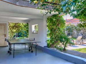 a ping pong table on the patio of a house at Holiday Home Villa Toni by Interhome in Umag