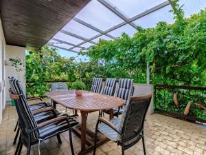 a patio with a wooden table and chairs at Holiday Home Villa Toni by Interhome in Umag