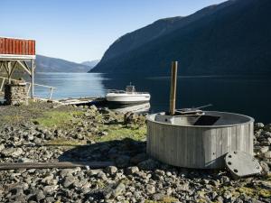 a tub sitting on the shore of a body of water at Holiday Home Tor by Interhome in Arnefjord
