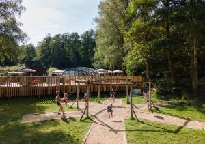 a group of people playing on a playground at Huttopia Vallée de la Semois in Vresse-sur-Semois