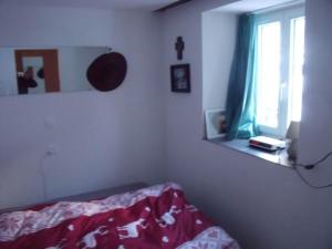 a bedroom with a bed and a mirror and a window at Apartment Diana by Interhome in Saas-Almagell