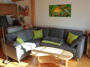 a living room with a couch and a table at Apartment Rottäli OG by Interhome in Lenk