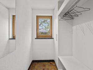 a hallway with a window and white walls at Apartment Bellavista 6 by Interhome in Parpan