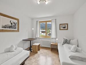 a living room with two white couches and a window at Apartment Bellavista 6 by Interhome in Parpan +19 photos