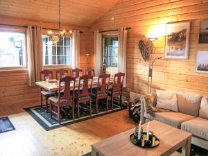 a living room with a couch and a table at Holiday Home Lettibu by Interhome in Madland