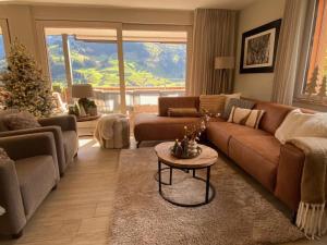 a living room with a couch and a christmas tree at Apartment Alpenrose by Interhome in Adelboden