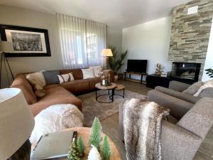 a living room with a couch and a fireplace at Apartment Alpenrose by Interhome in Adelboden +61 photos