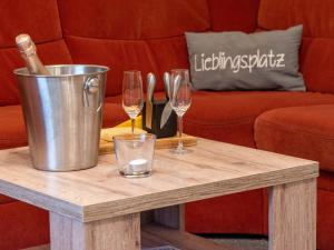 a coffee table with wine glasses and a bucket at Holiday Home Kiel by Interhome in Norddeich