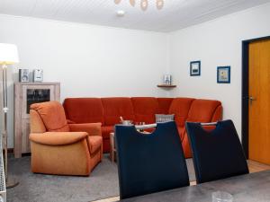 a living room with a couch and two chairs at Holiday Home Kiel by Interhome in Norddeich