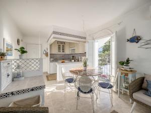 Una cocina y un comedor con mesa y sillas. en Holiday Home Los Geranios by Interhome, en Roses
