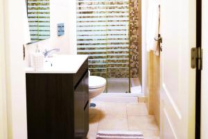 a bathroom with a sink and a toilet at Fonte do Cabo Apartment in Ericeira +32 photos