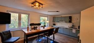 a kitchen with a desk and chairs in a room at Ruhiges Haus im Grünen mit Whirlpool & 3 Schlafzimmern nahe Messe Essen in Essen