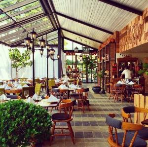 a restaurant with tables and chairs and people sitting at tables at Armonia 24 suites by Yellowkey in Los Prados