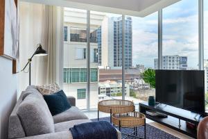 a living room with a couch and a large window at Armonia 24 suites by Yellowkey in Los Prados