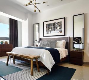 a bedroom with a large bed and a wooden table at Armonia 24 suites by Yellowkey in Los Prados