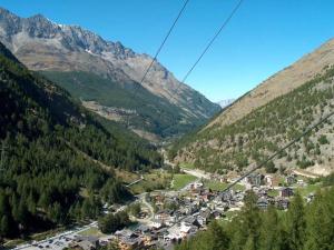 a town in a valley in the mountains at Apartment Haus Alpenrose by Interhome in Saas-Almagell +29 photos