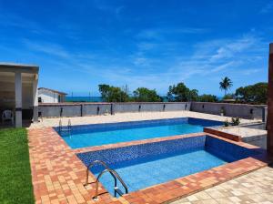 a swimming pool in the backyard of a house at Hostel Vista Mar in Porto Seguro