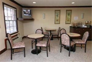 a group of tables and chairs in a room at Yorktown Motor Lodge in Yorktown