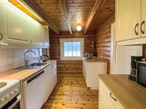 a kitchen with wooden walls and a wooden floor at Chalet Krampehaugen by Interhome in Utvik +23 photos