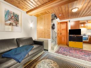 a living room with a couch and a tv at Holiday Home Lätthaus Rot by Interhome in Täsch +26 photos