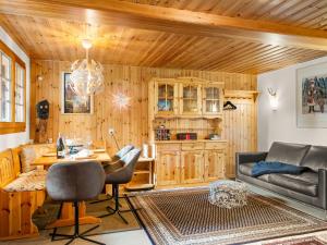 a living room with a couch and a table at Holiday Home Lätthaus Rot by Interhome in Täsch