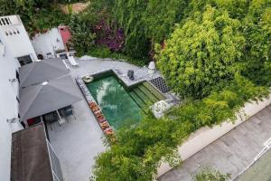 an overhead view of a swimming pool with an umbrella at Casamea - Villa, Piscine, Vue Mer, Sanguinaires in Ajaccio