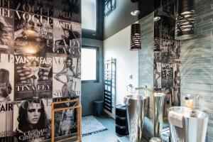 a bathroom with a sink and posters on the wall at Casamea - Villa, Piscine, Vue Mer, Sanguinaires in Ajaccio