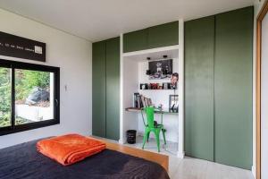 a bedroom with green walls and a bed and a green chair at Casamea - Villa, Piscine, Vue Mer, Sanguinaires in Ajaccio +10 photos