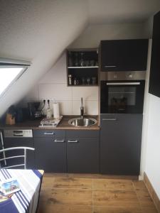 a kitchen with a sink and a stove at Landurlaub Mecklenburgische Seenplatte B Waren Müritz in Schwarzenhof