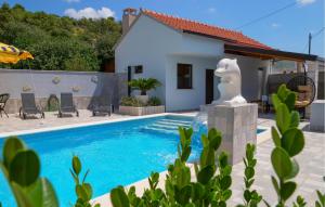 a villa with a swimming pool and a house at 3 Bedroom Amazing Home In Vinovac in Kruševo