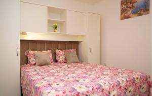 a bedroom with a large bed with pink sheets and pillows at 3 Bedroom Amazing Home In Vinovac in Kruševo