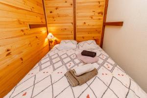 a bedroom with a bed with two towels on it at Au Doubs Refuge in Métabief +22 photos