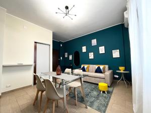 a living room with a table and a couch at Le Dimore del Corso in Catania