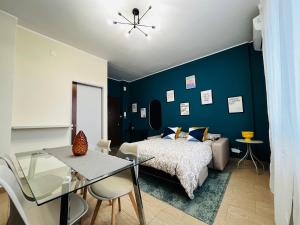 a bedroom with a bed and a glass table at Le Dimore del Corso in Catania