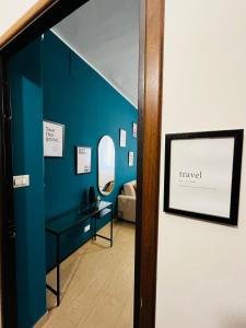 a room with a blue wall with a vanity and a mirror at Le Dimore del Corso in Catania