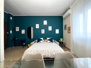 a bedroom with a bed and a blue wall at Le Dimore del Corso in Catania
