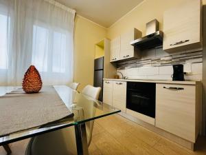 a kitchen with a glass table and a counter top at Le Dimore del Corso in Catania