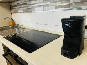 a black coffee maker on a counter in a kitchen at Le Dimore del Corso in Catania