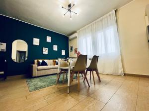 a living room with a table and chairs and a couch at Le Dimore del Corso in Catania