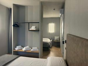 a bedroom with a bed and a room with a bed at RE Versiliana Junior-House in Marina di Pietrasanta