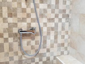 a shower with a hose in a bathroom at Villa Rebeka in Šilo +56 photos
