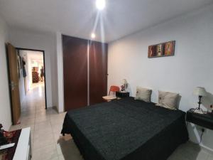 a bedroom with a black bed in a room at MALLORCA Aparts in Colón