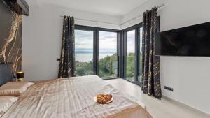 a bedroom with a bed and a large window at Villa Gabi by Villas Holiday in Donji Rukavac +32 photos