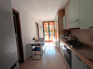 a kitchen with a counter and a table in it at La Casa di Gabriele by Holiday World in Bondone +15 photos