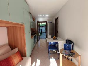 a living room with a table and a kitchen at La Casa di Gabriele by Holiday World in Bondone