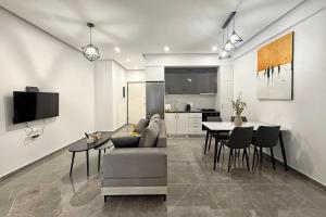 a living room with a couch and a table at Cozy Home With Cooking Near Tram in Piraeus