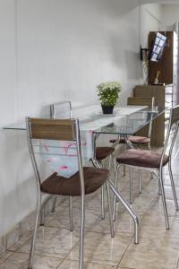 a dining room table with chairs and a glass top at Departamento sobre Av San Jose in Ciudad del Este +2 photos