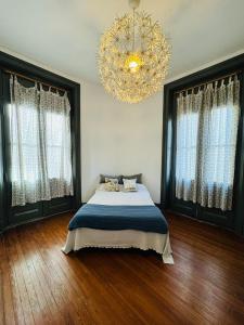 a bedroom with a bed and a chandelier at Malala in Buenos Aires